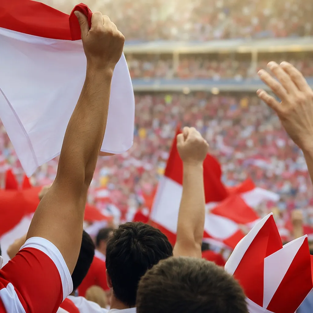 Close-up of football fans holding generic national team flags in a stadium, chee