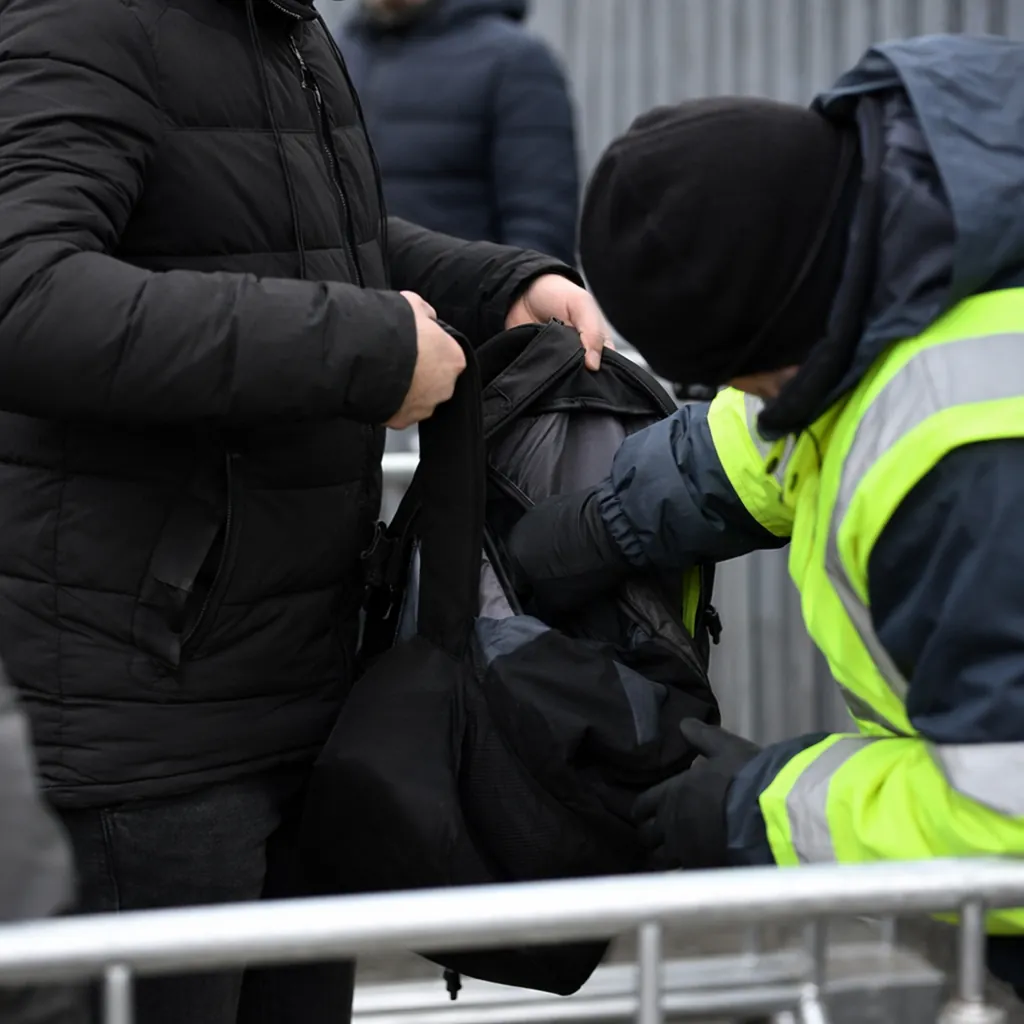 Close up shot of a generic football match entrance security check point, staff c