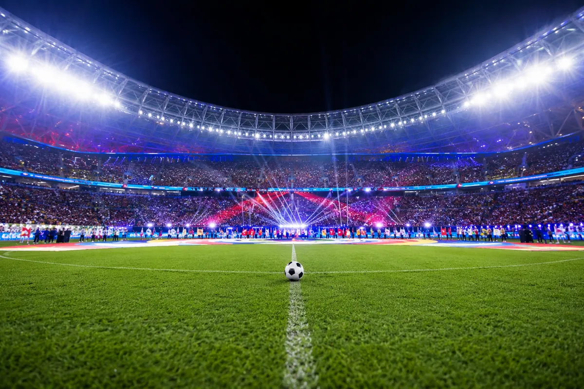Wide shot of a vibrant football stadium during World Cup opening ceremony, bright stadium