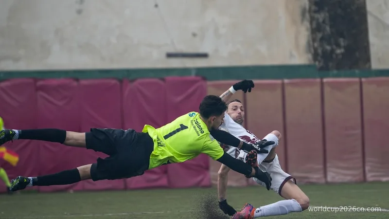 Goalkeeper dives to save a soccer ball during a game.