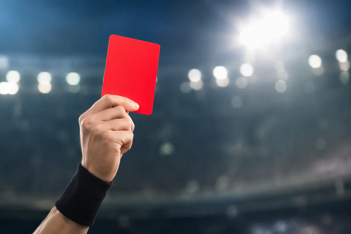 Editorial sports news header image, blurred soccer stadium background with bright floodlig