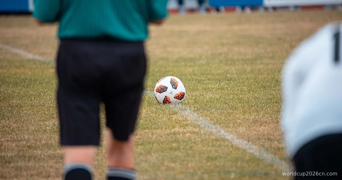 man in green shirt and black shorts playing soccer during daytime