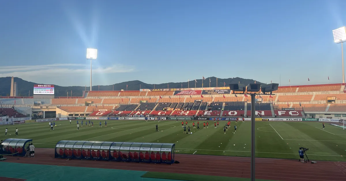 Professional football news header image, blurred football stadium background with warm gol