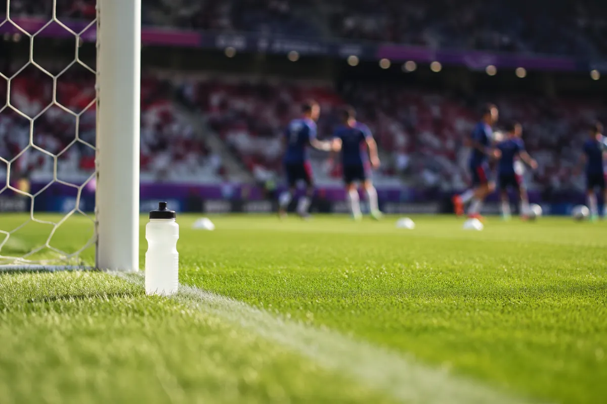 Professional football training ground during world cup, sunlight shines on the sideline ne