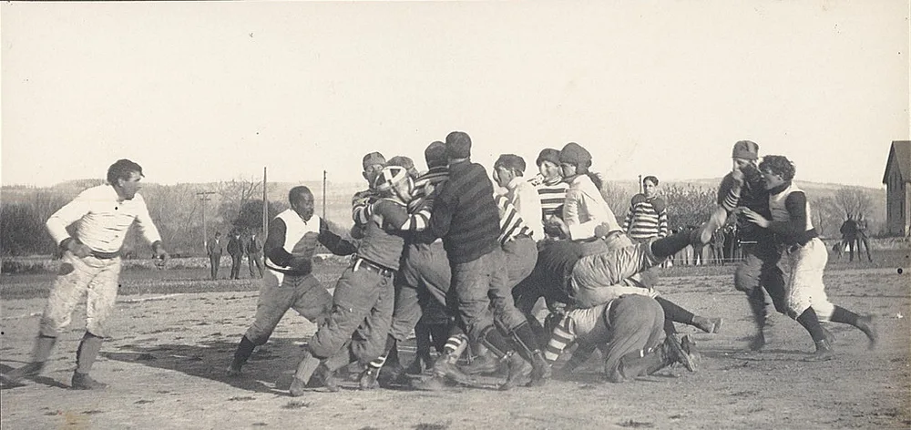 Close up of lightweight rubber youth football placed on green training pitch, no