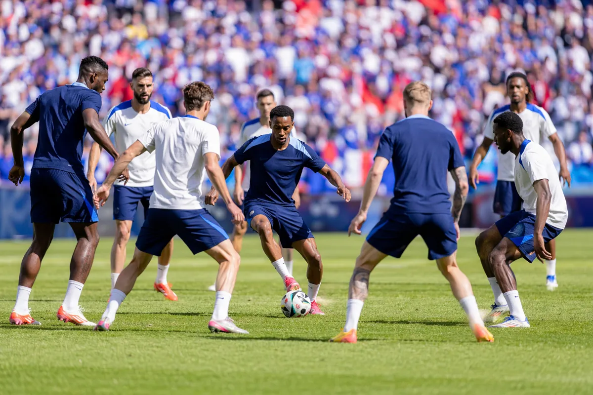 Wide shot of national football team training on a sunny green pitch, blue and white team k