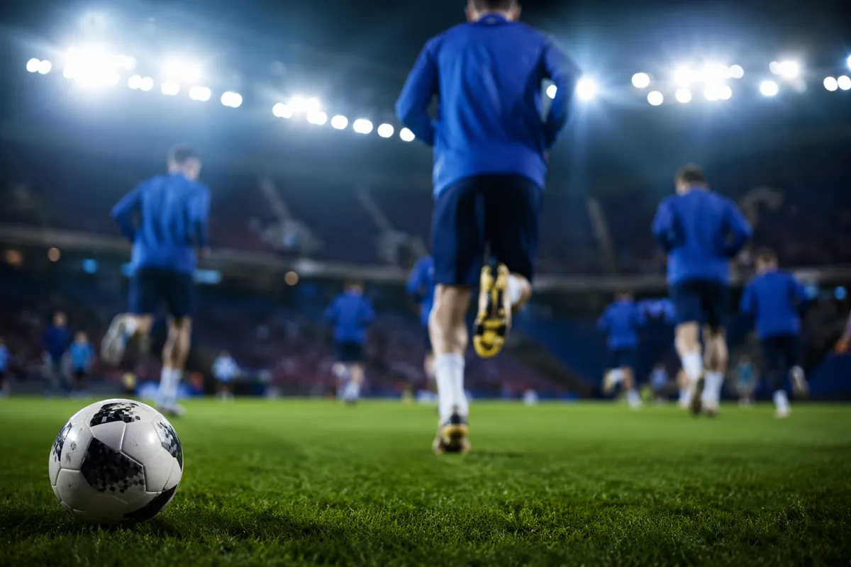Professional sports news header image, blurred background of football players in blue jers