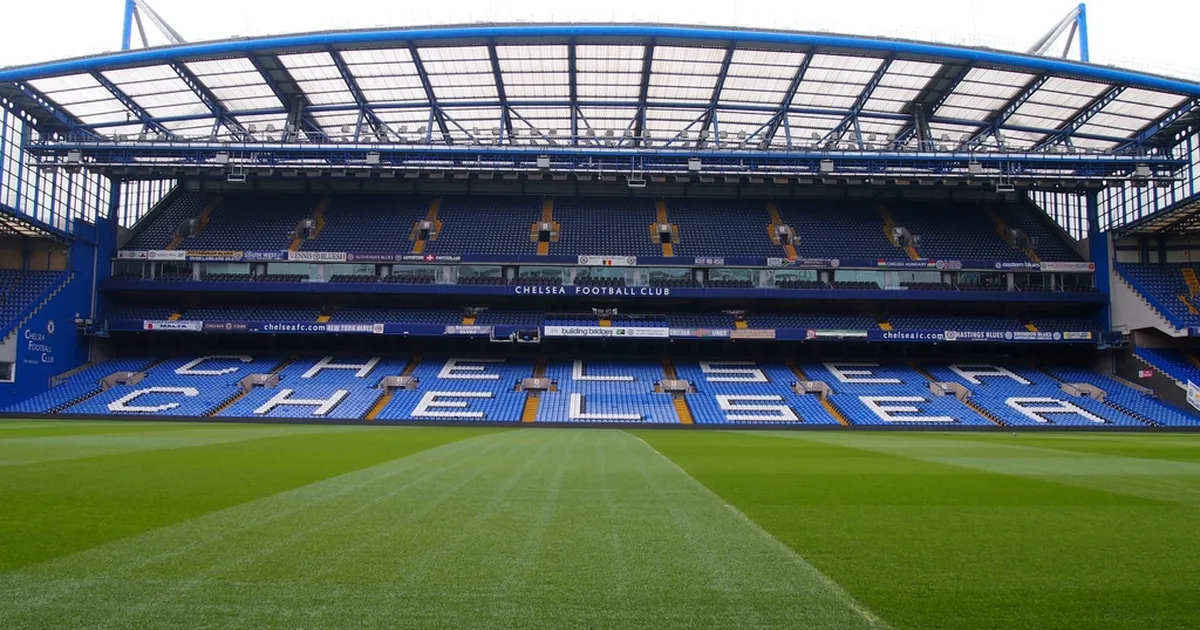 Professional football transfer announcement background, blurred football stadium interior