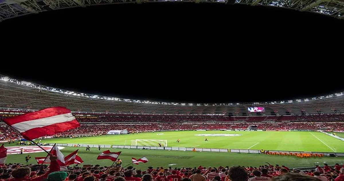 Professional football match action shot, Bundesliga stadium interior, green pitch with blu