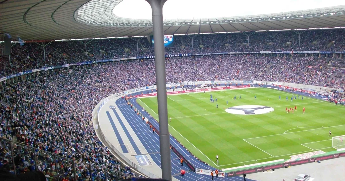 Professional football editorial header image, wide shot of a modern European football stad