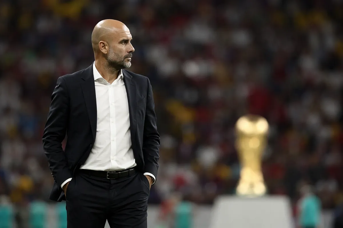 Professional football coach standing on the touchline of a large World Cup style stadium,