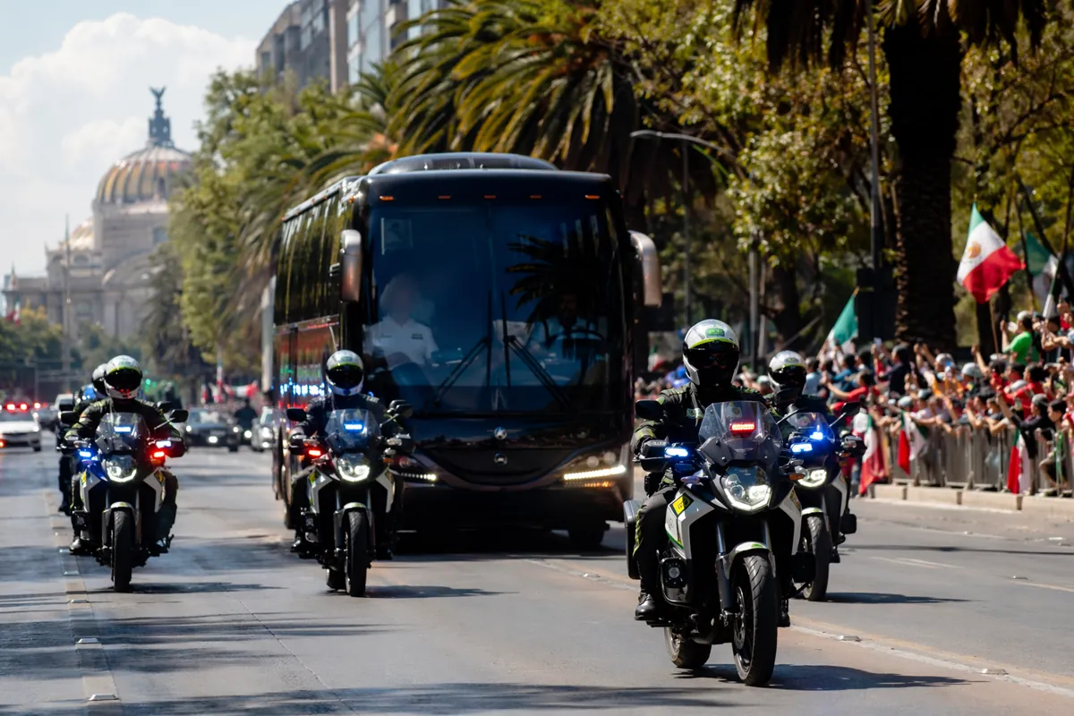 Professional editorial news photograph, police motorcycles escorting a team coach through