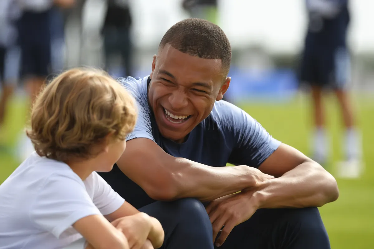 Professional football training ground, blurred figure of a young football player laughing