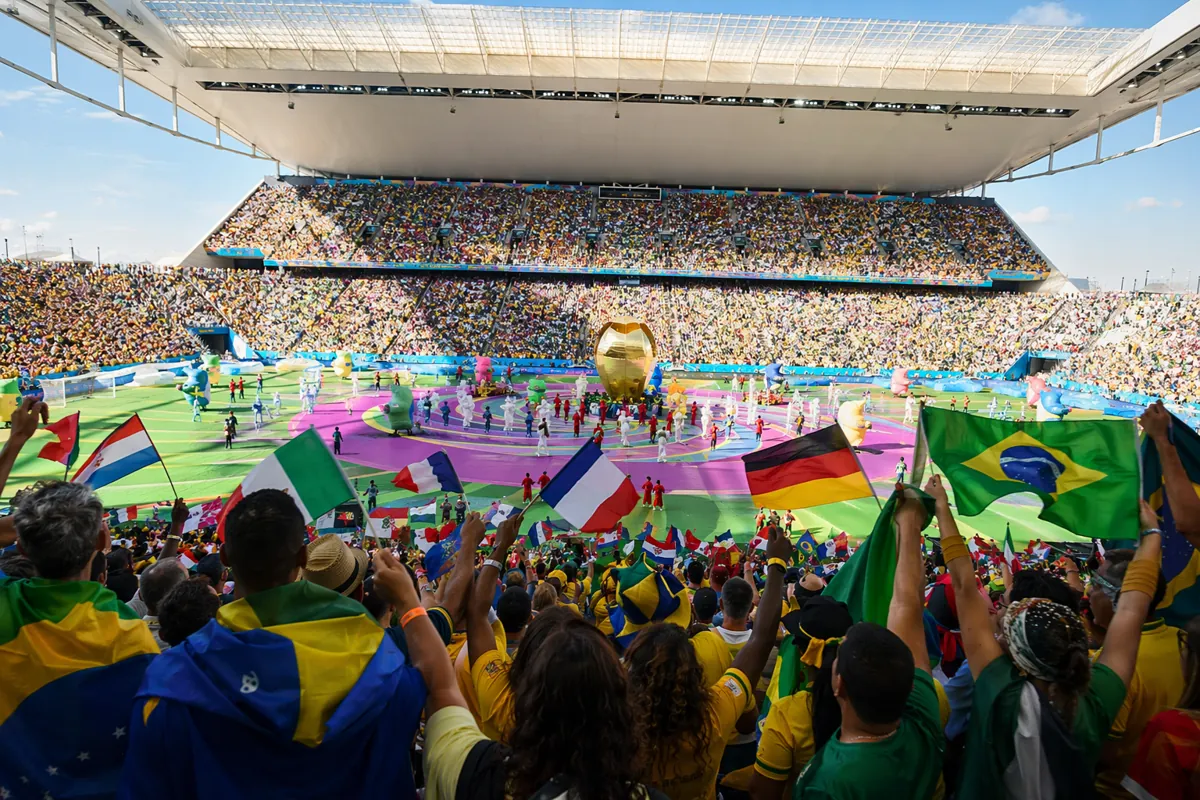 Editorial news photo of a vibrant World Cup opening ceremony setup in a large modern stadi