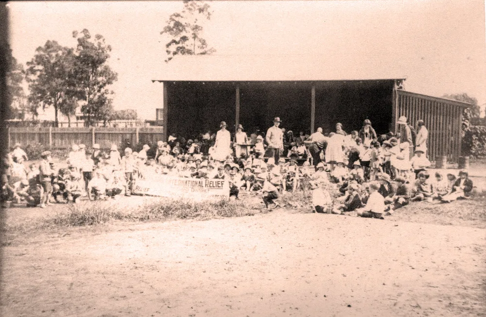 Generic charity relief scene with volunteers sorting supplies, no identifiable p