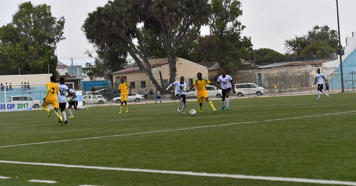 Professional football stadium during an international match, blurred players in action on