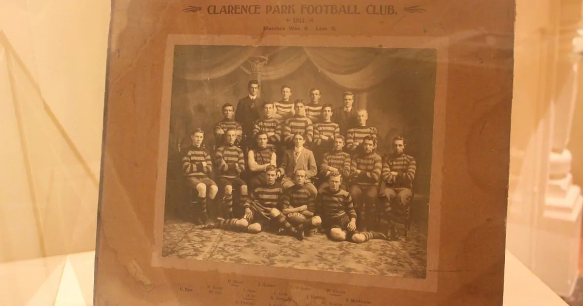 A professional football club museum exhibition space, with bronze statues of football play