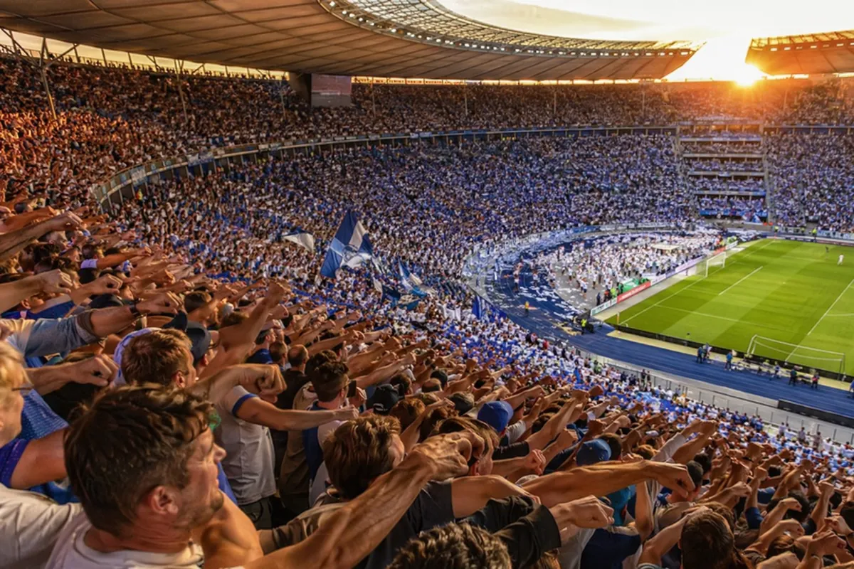 Editorial news feature photo, wide shot of a packed 90000-capacity football stadium, crowd