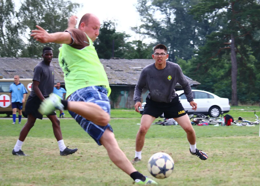 Wide shot of modern European football stadium interior with empty seats, natural
