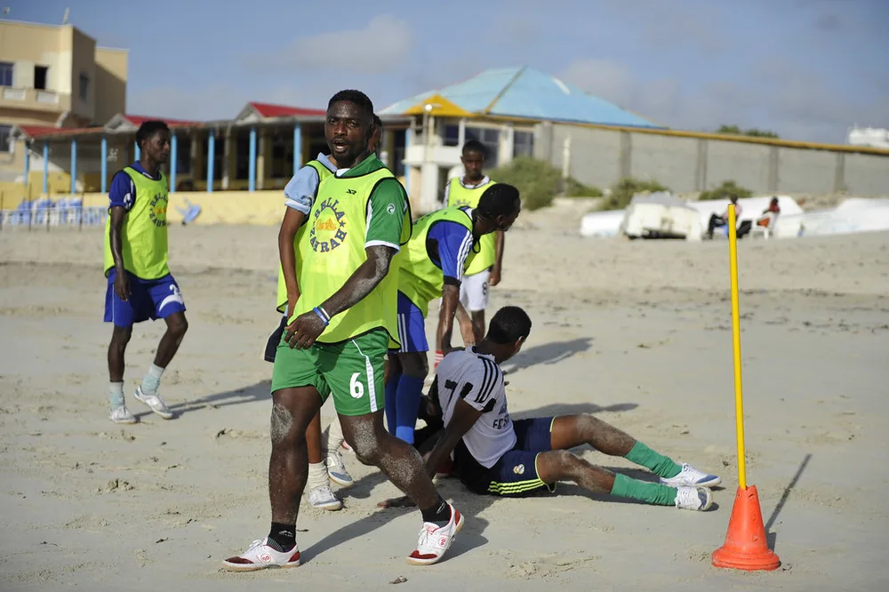 Generic football training ground scene, players in unbranded training kits doing