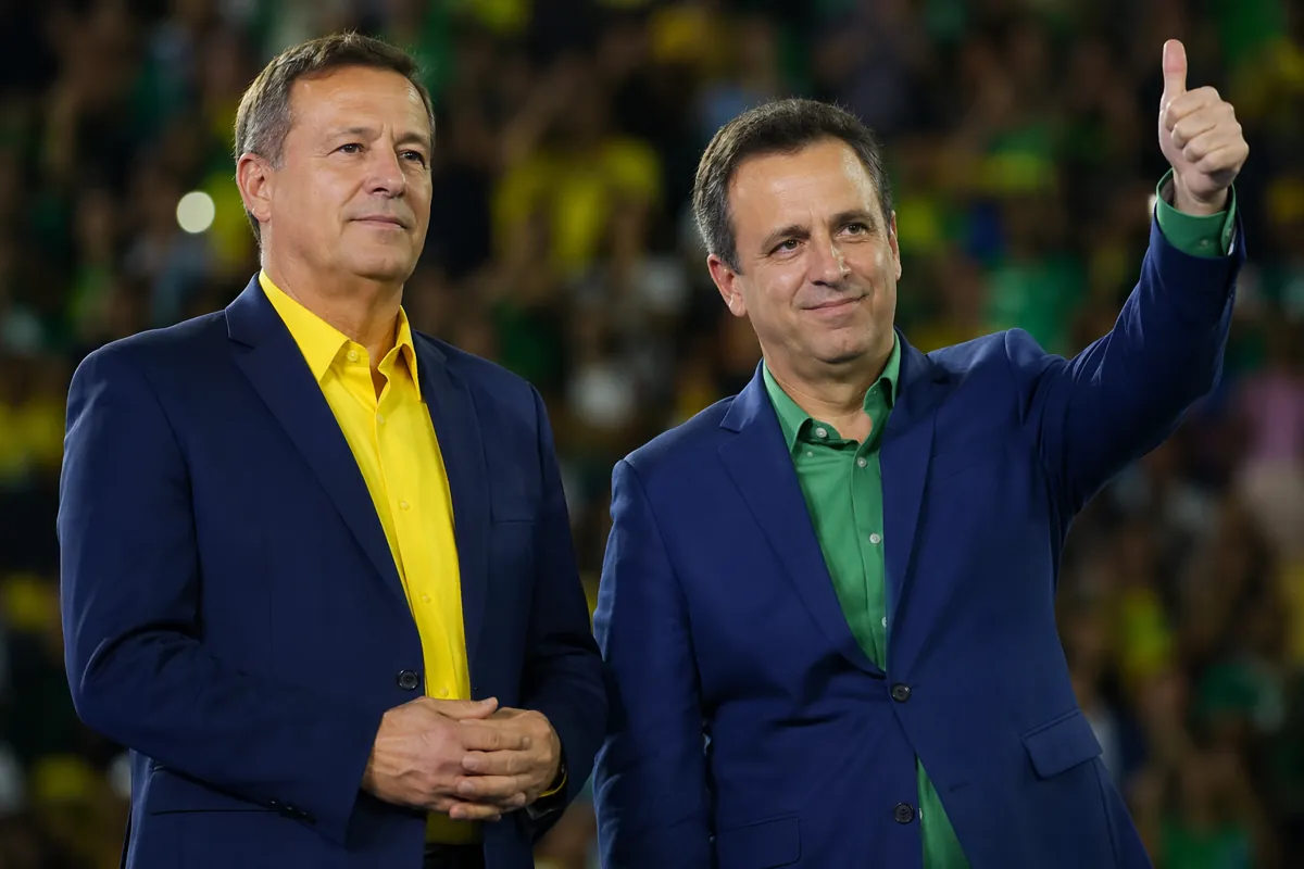 Two anonymous middle-aged men in casual suits with Brazilian flag color accents, standing