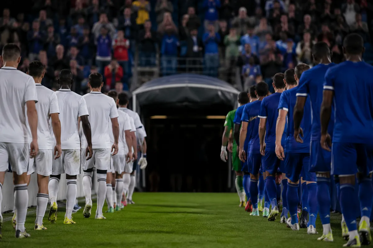 Professional sports news header image, two groups of football players walking towards the