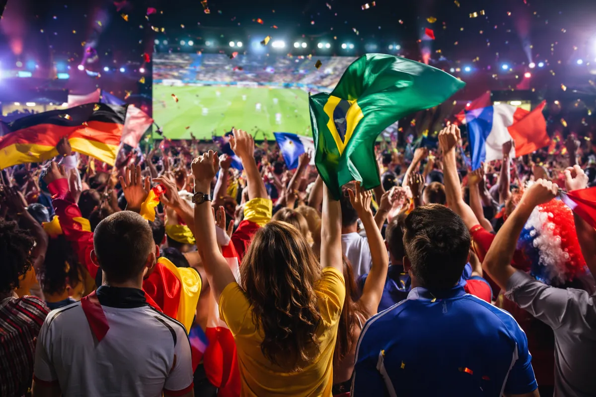 Wide shot of a vibrant World Cup viewing party with excited anonymous football fans cheeri
