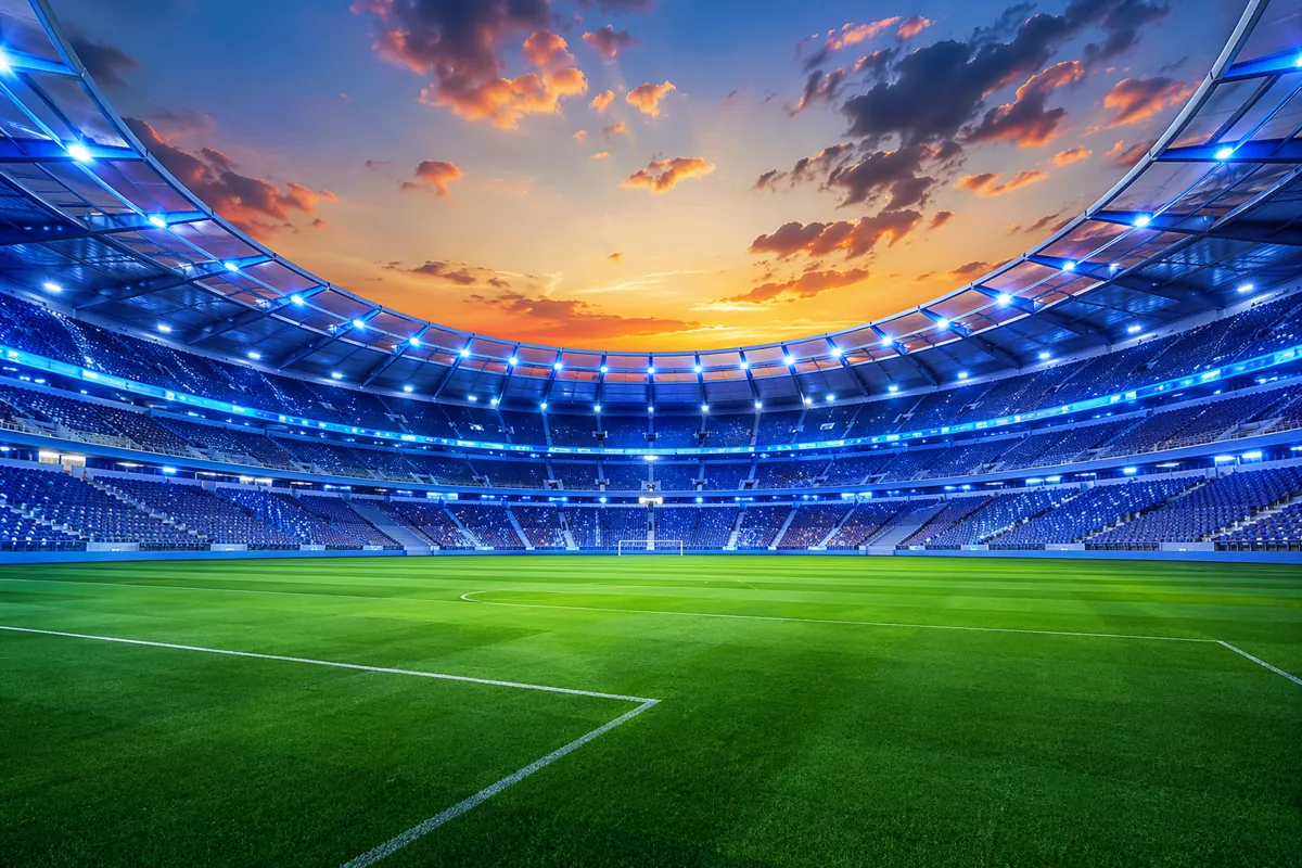 A modern football stadium at sunset with bright neon lighting, blue and white color scheme