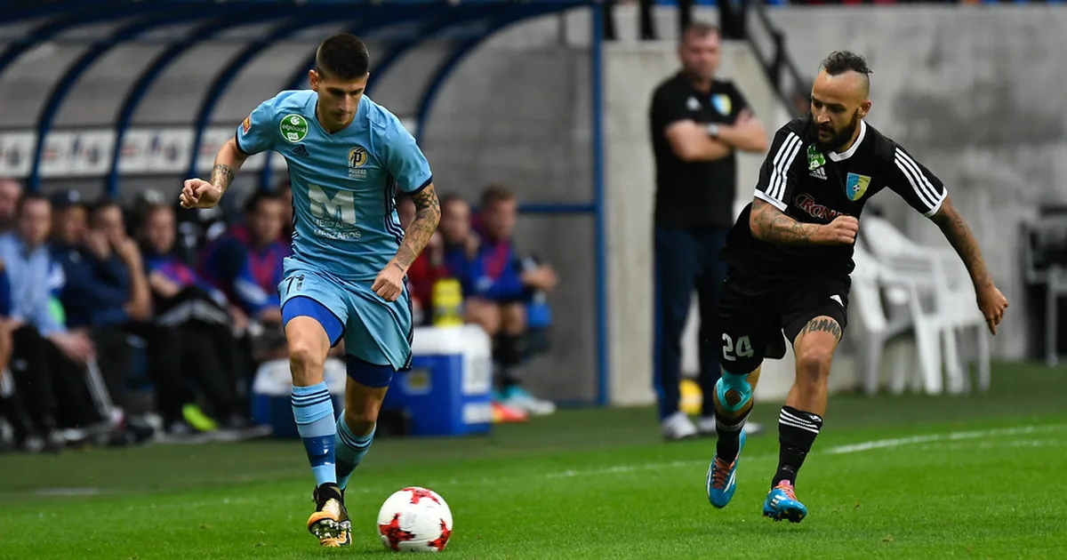 Professional football match scene, two teams competing for the ball in the midfield of a m